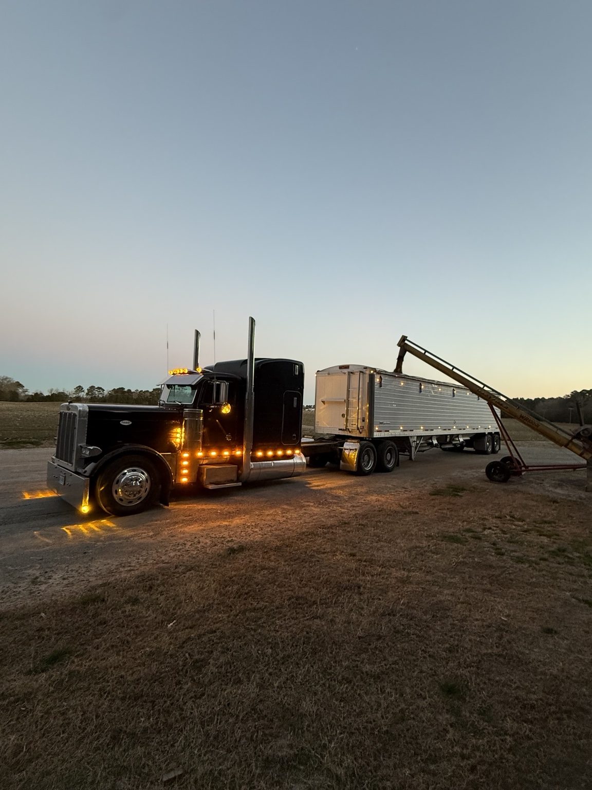 DQS Transport truck and hopper trailer at dusk