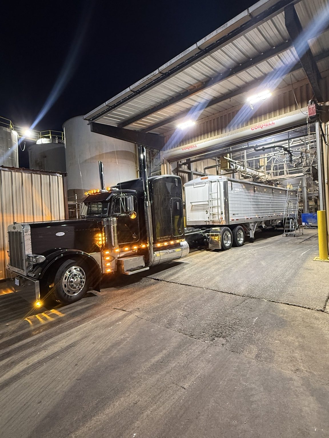DQS Transport truck at a facility at night