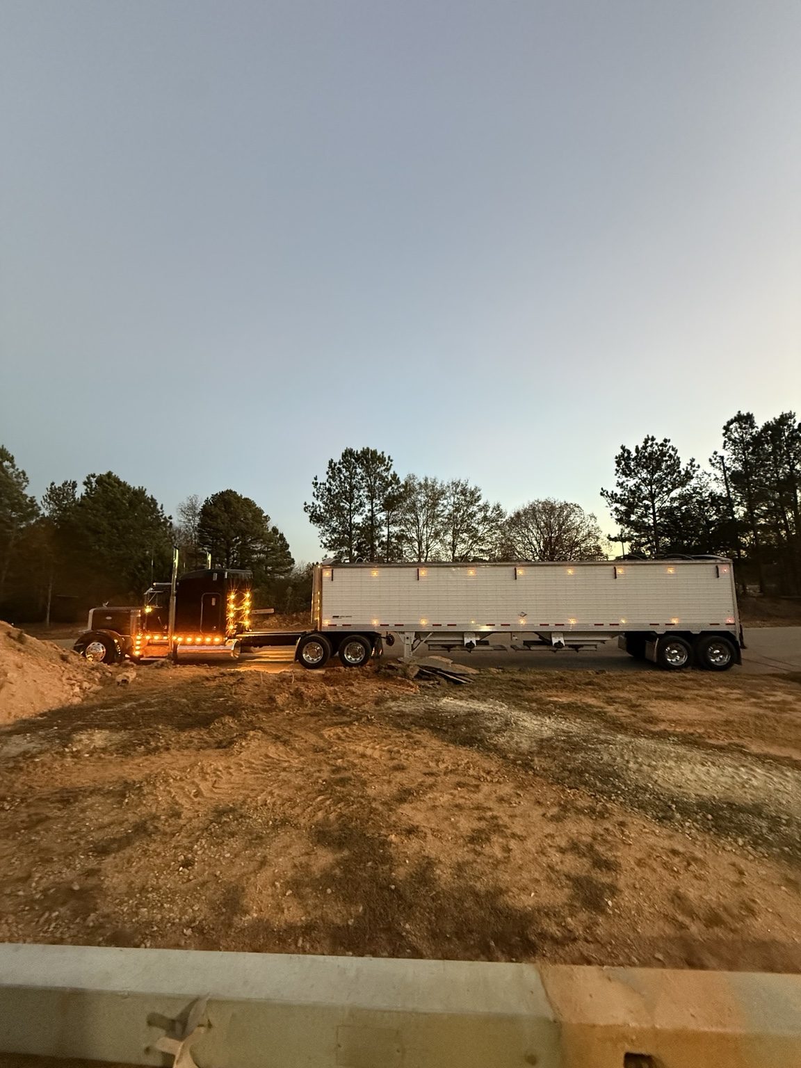 Side profile of DQS Transport truck and hopper trailer